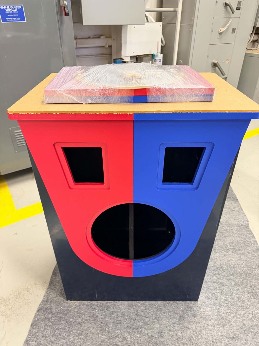 A red and blue face-off podium being built in the workshop